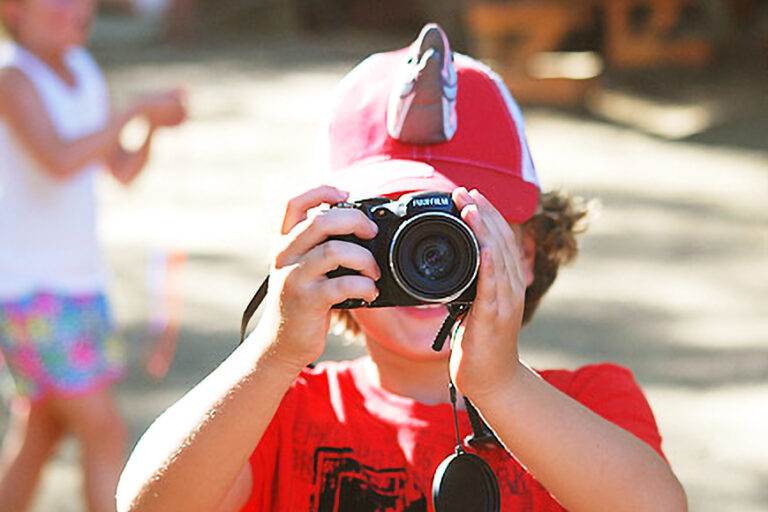 boy looking through a camera.