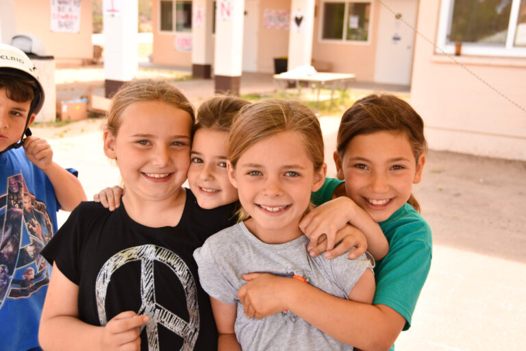 group of girls huddling together and smiling.