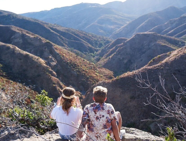 two teens overlooking canyon.