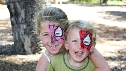boy and a girl smiling with matching spiderman facepaint