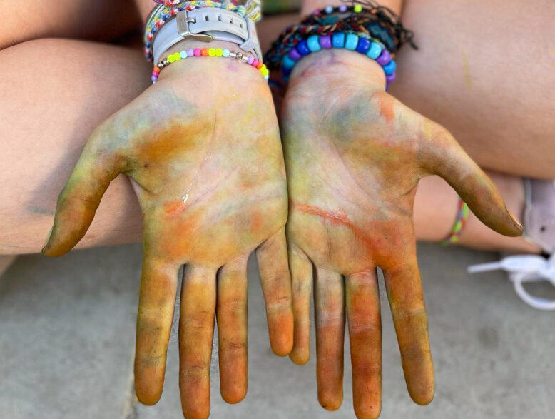 two hands covered in paint.
