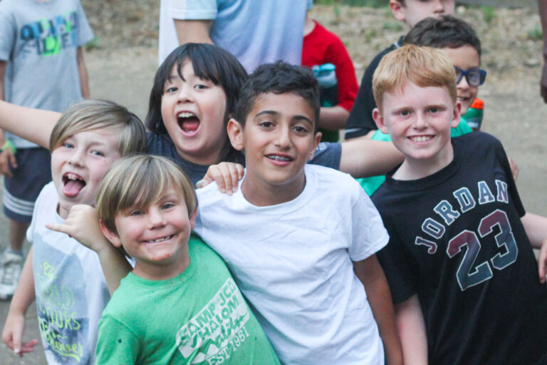 group of smiling young boys outside.