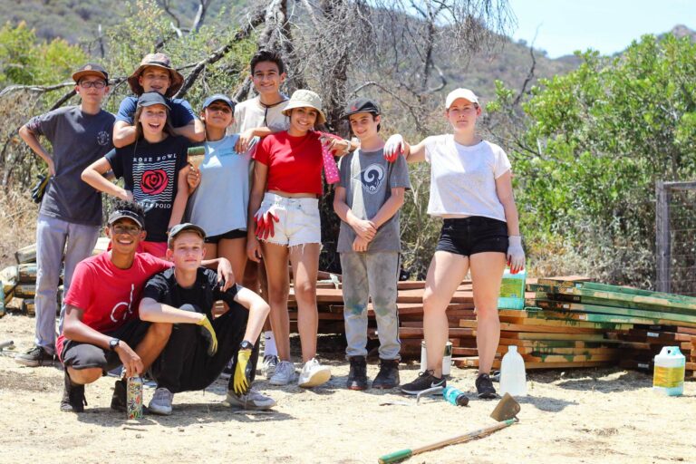 group of teens outside smiling.