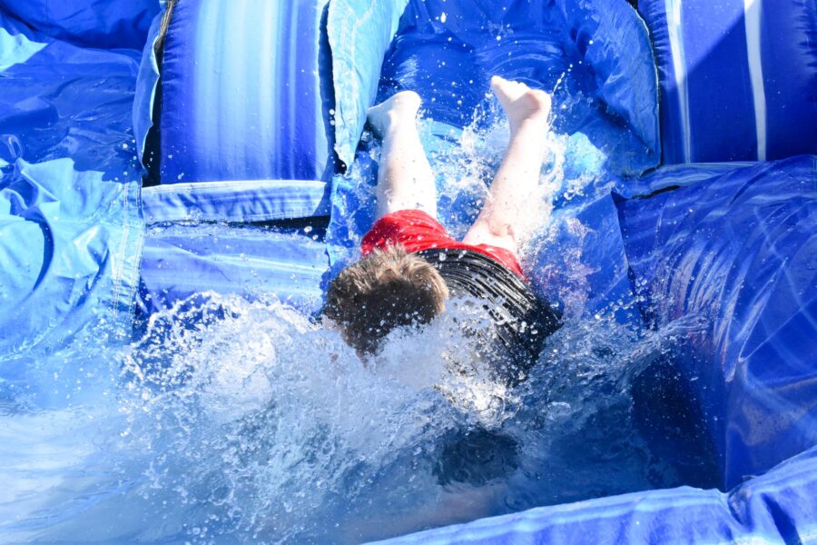 boy wiping out in a water slide.